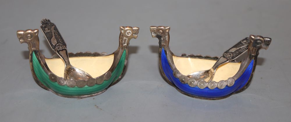 A pair of Norwegian white metal and enamel Viking boat salts, 67mm and two associated spoons, gross 80 grams.